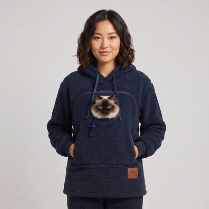 Woman wearing the navy blue Dolgum Cozy Cat Hoodie with a Siamese cat in the front pouch